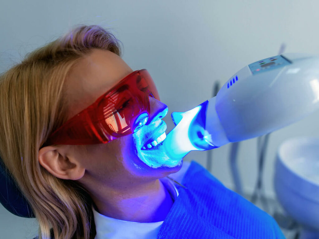 A patient gets her teeth whitened