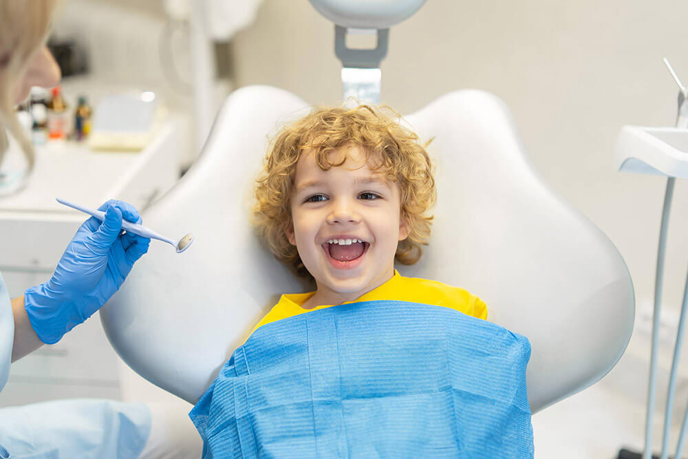 A boy receives pediatric dental care