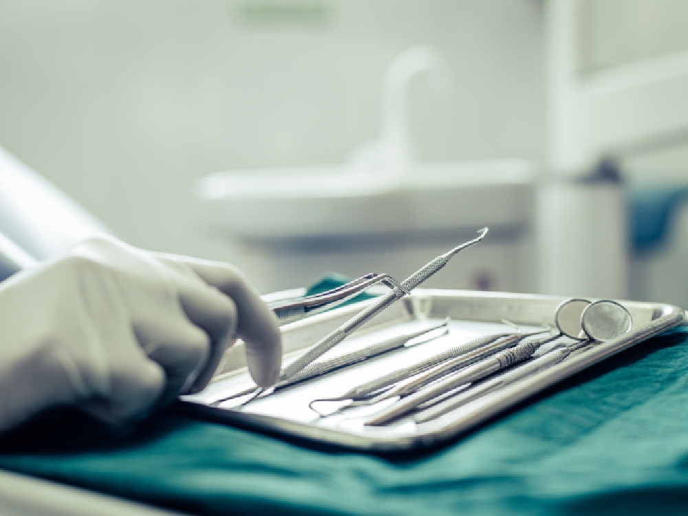 A dentist prepares for oral surgery